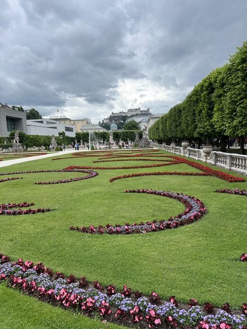 Mirabell Gardens, looking in the direction of Hohensalzburg Fortress on a cloudy day.